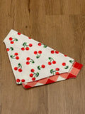 cherries on white background bandana with red and white checkered pattern on the back. 
