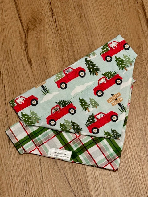 Two fabric swatches with Christmas truck and tree patterns on a wooden surface